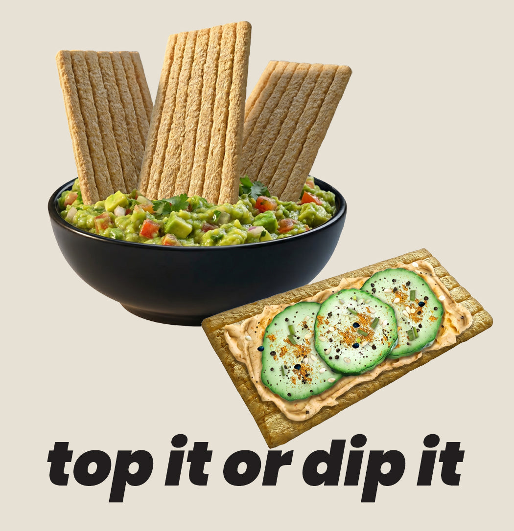 Bowl of guacamole with crispbreads and a crispbread with hummus spread and cucumber slices on a beige background.